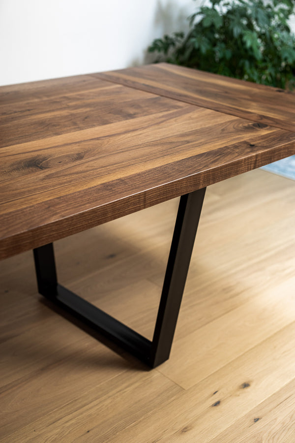 black walnut dining table with black metal base